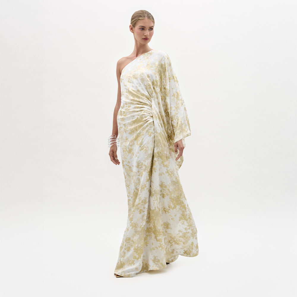 Woman wearing a white and gold floral dress on a white background