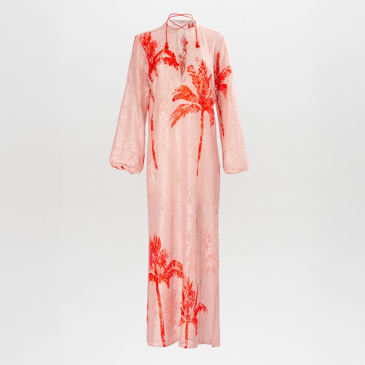 The Mayfair Tunic is a long-sleeved, floor-length pink dress featuring a high neckline and red palm tree prints.