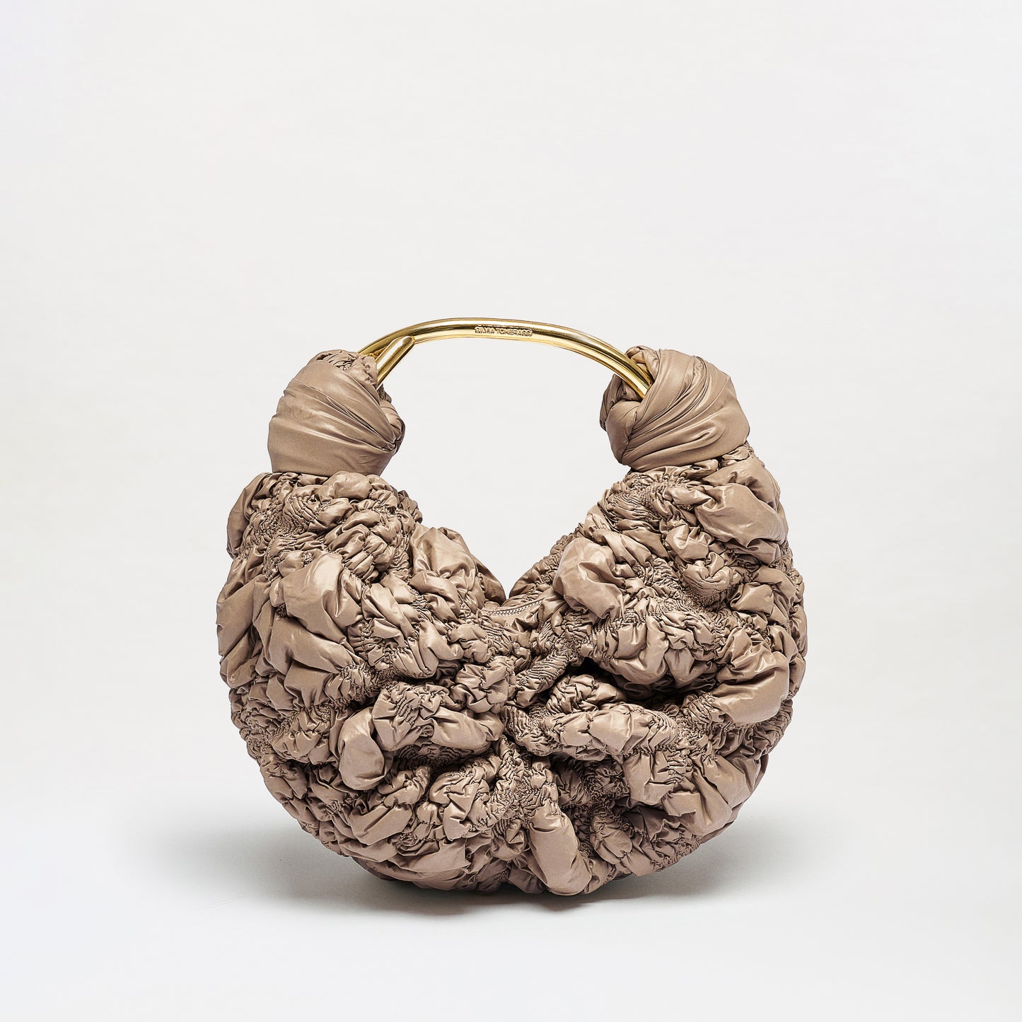 The Sofia Bag (Small) is a beige, textured handbag with a puffy ruched design and a rounded gold handle, shown against a plain white background.
