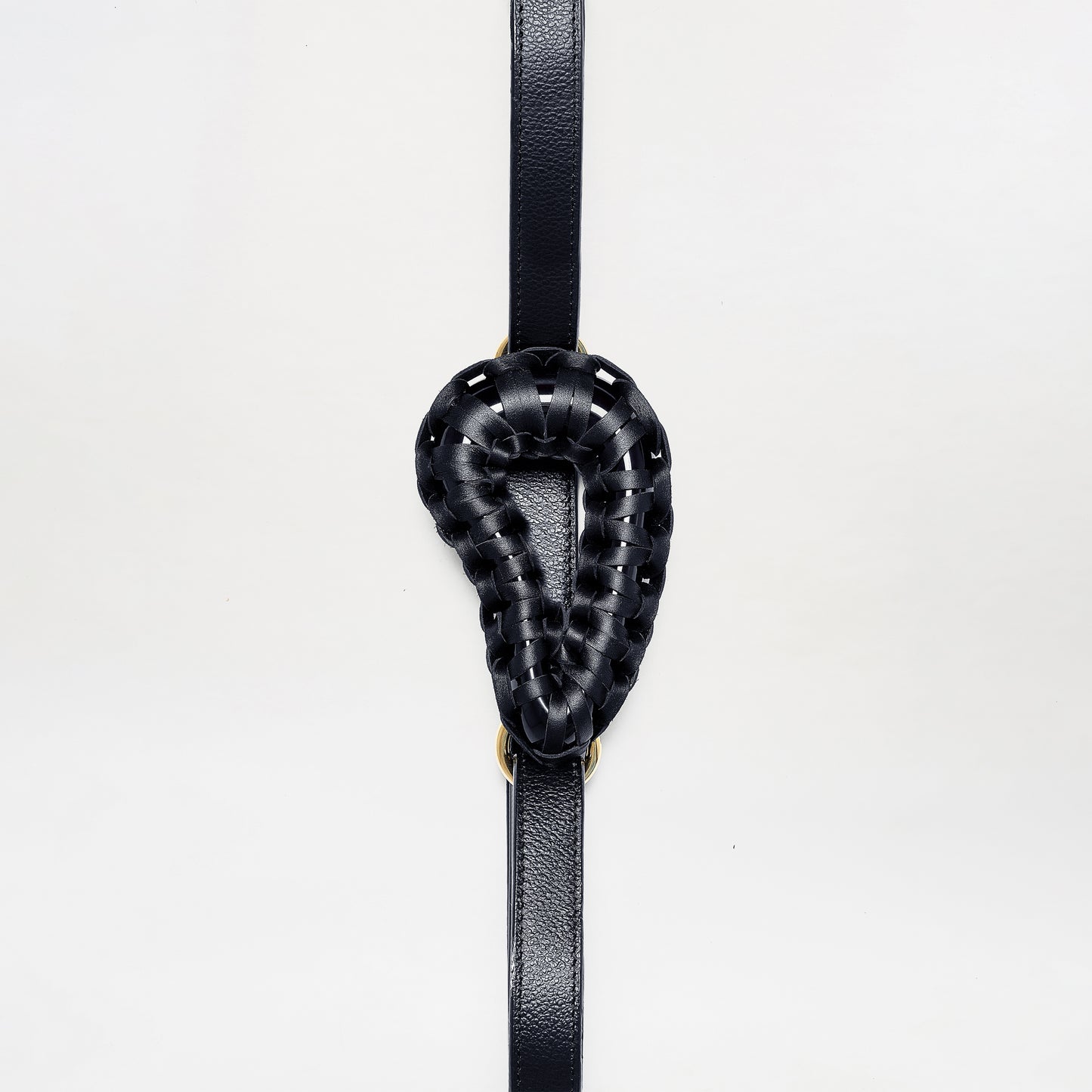 The Renata Belt features a black woven leather loop in a teardrop shape, centered on a vertical black leather strap, shown against a plain white background.