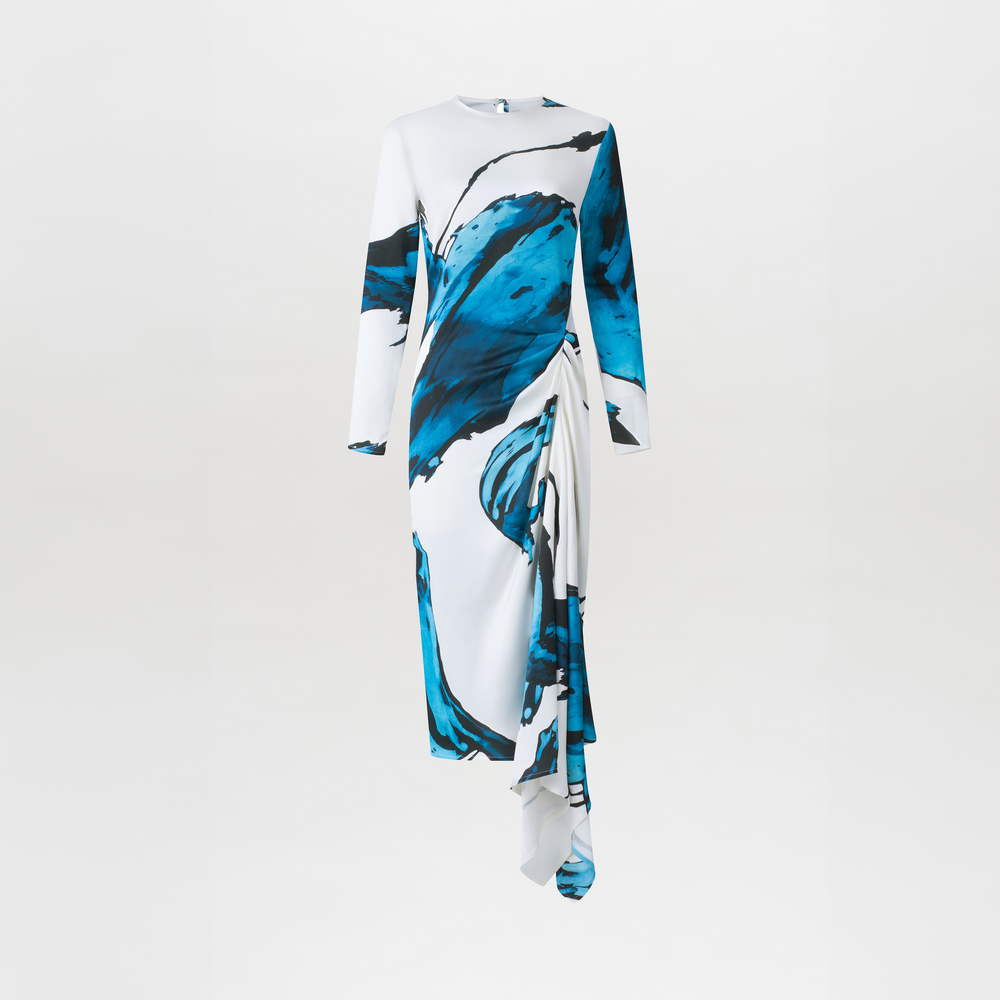 Ananya Dress Multi Abstract Waves with bold blue abstract print design, featuring an asymmetrically draped skirt, displayed on a white background.