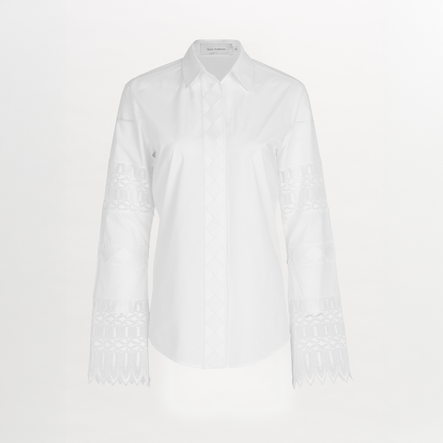 A Aspasia Blouse White with guipure lace detailing on the sleeves.