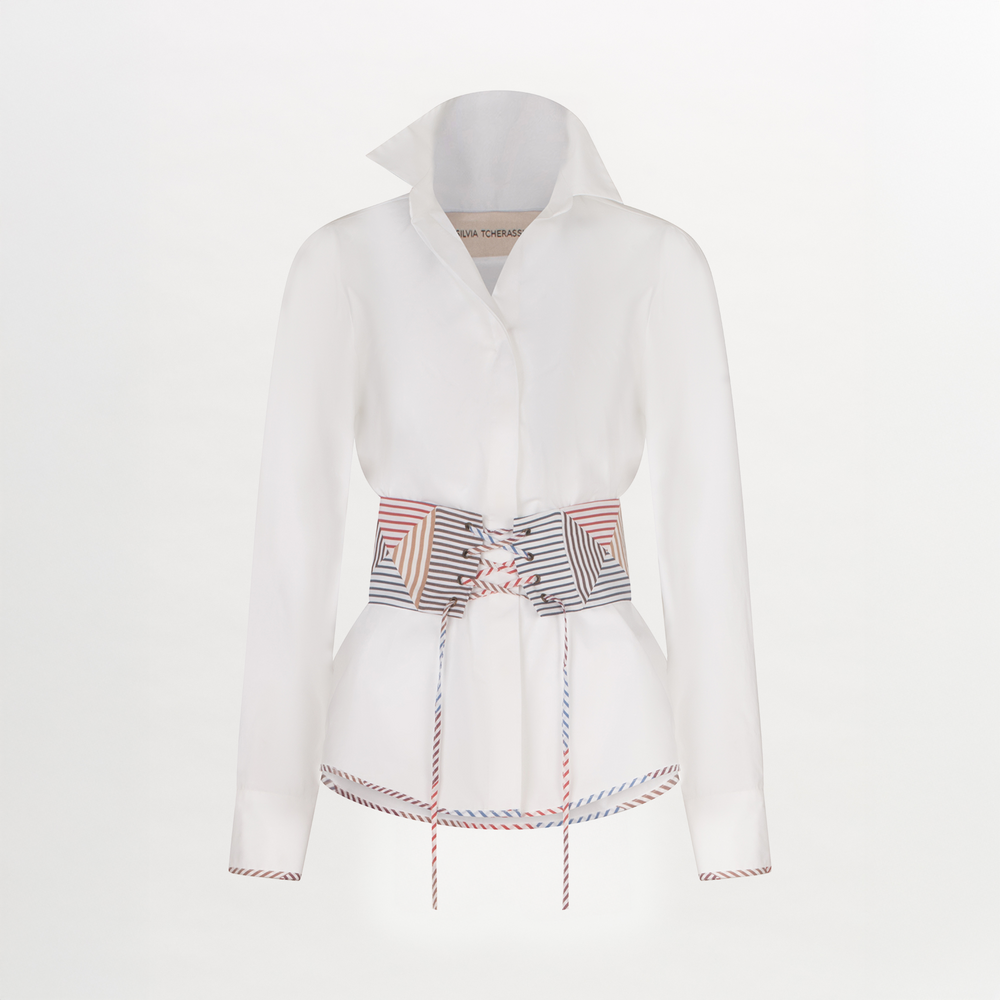 A Berenice Blouse White with a colorful belt and a fitted silhouette.