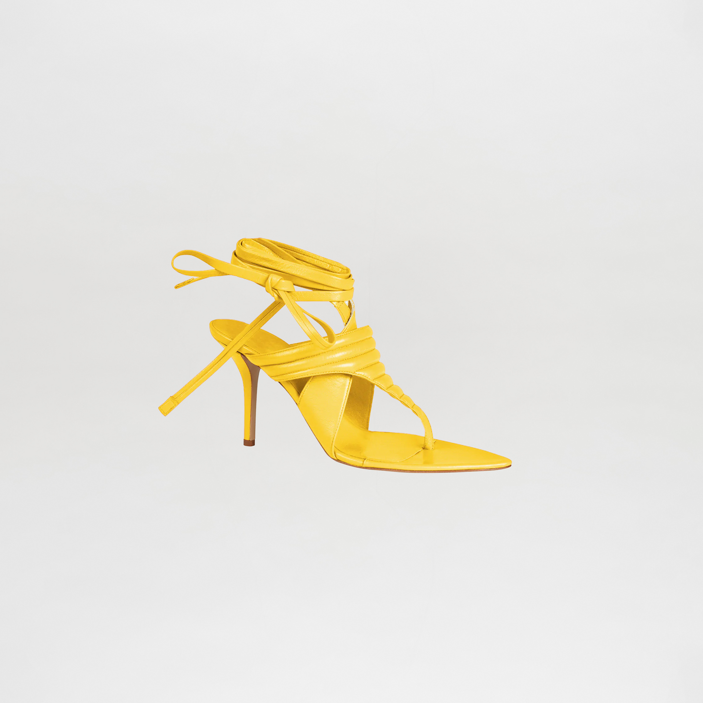 Yellow high-heeled sandal on a light gray background