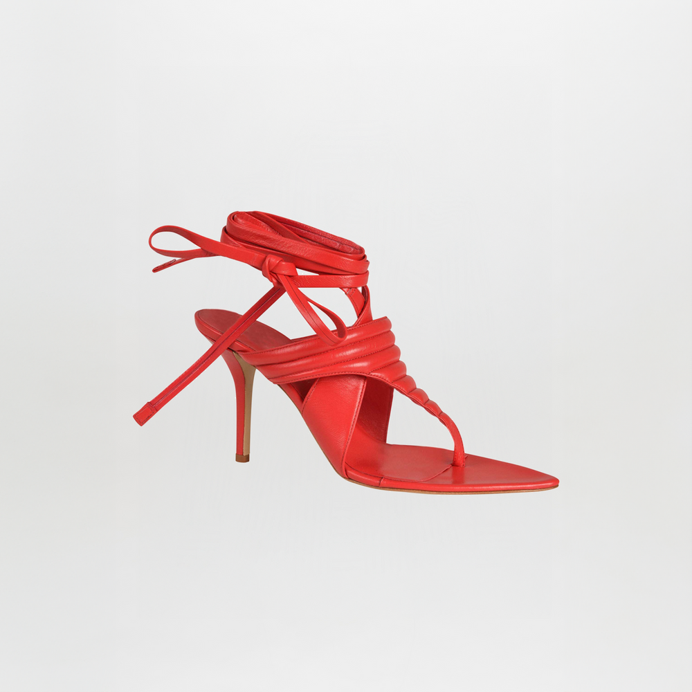 Dalila Heels Red crafted from Italian calf leather with a square toe, thin stiletto heel, wrap-around ankle straps, and quilted toe-thong design are shown against a plain white background.