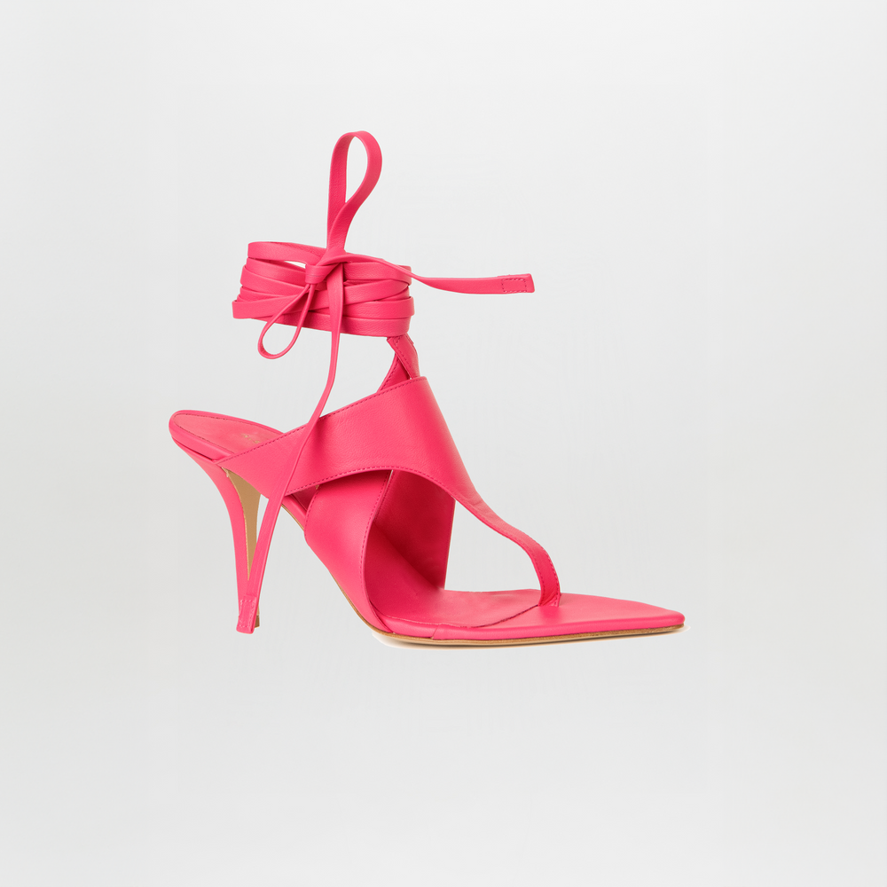 The Domenico Heels Fucsia by GIA Couture is a bright pink high-heeled sandal with Italian leather, a pointed toe, ankle wrap straps, and a thin heel, shown against a plain white background.