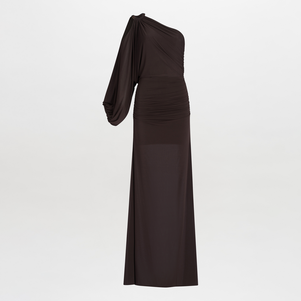 Woman in a Farah Dress Brown, a one-shoulder evening gown with leather ring detailing, posing in a studio setting.