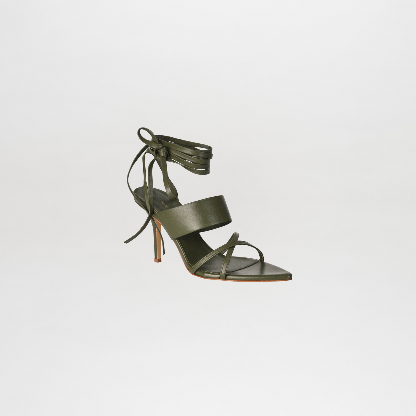 Green sandal with multiple straps on a light gray background