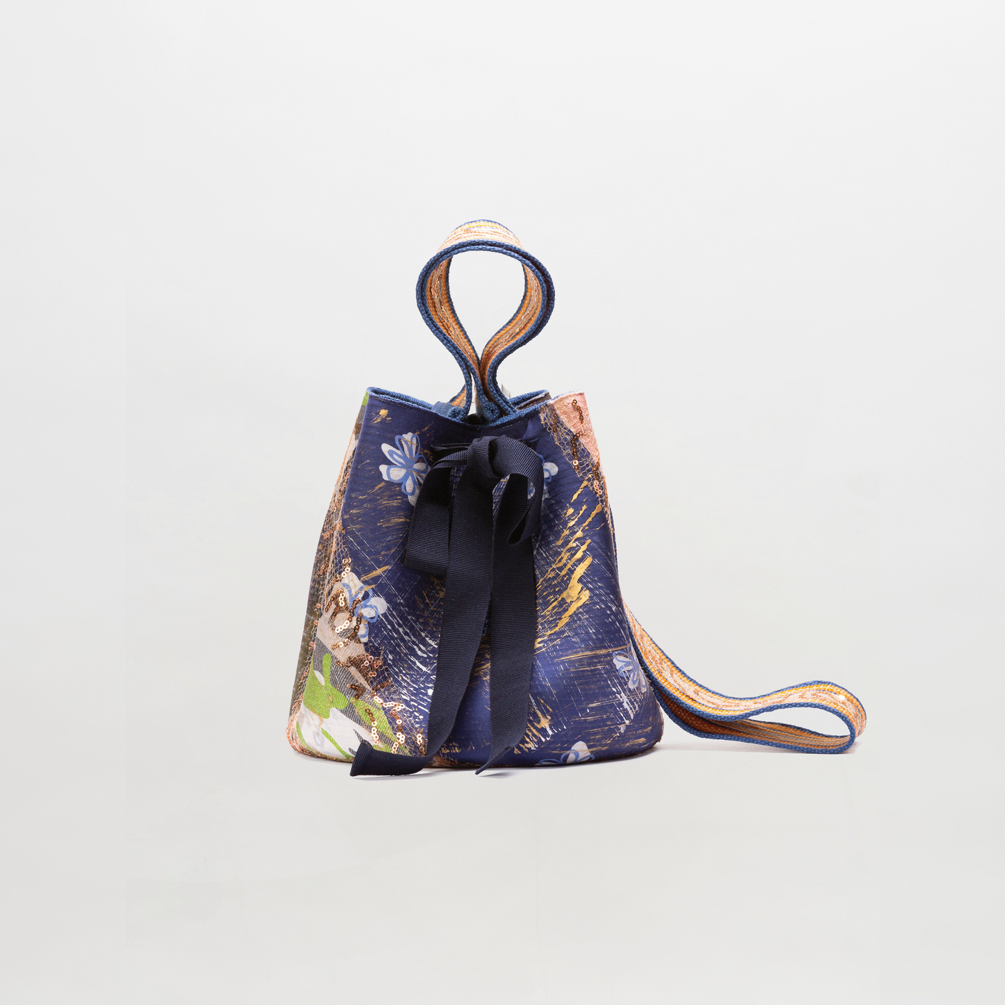 Small drawstring bag with floral pattern and black ribbon on a light gray background