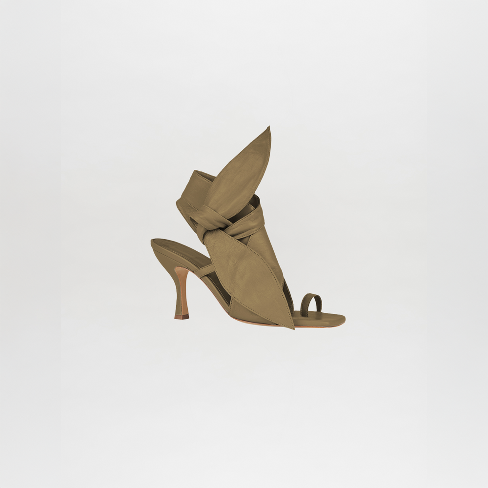 The Marco Heel Olive Green is a high-heeled sandal in olive green Italian calf leather, featuring a sculptural design with large leaf-like details and an open toe, from the Silvia Tcherassi collection, shown on a plain white background.