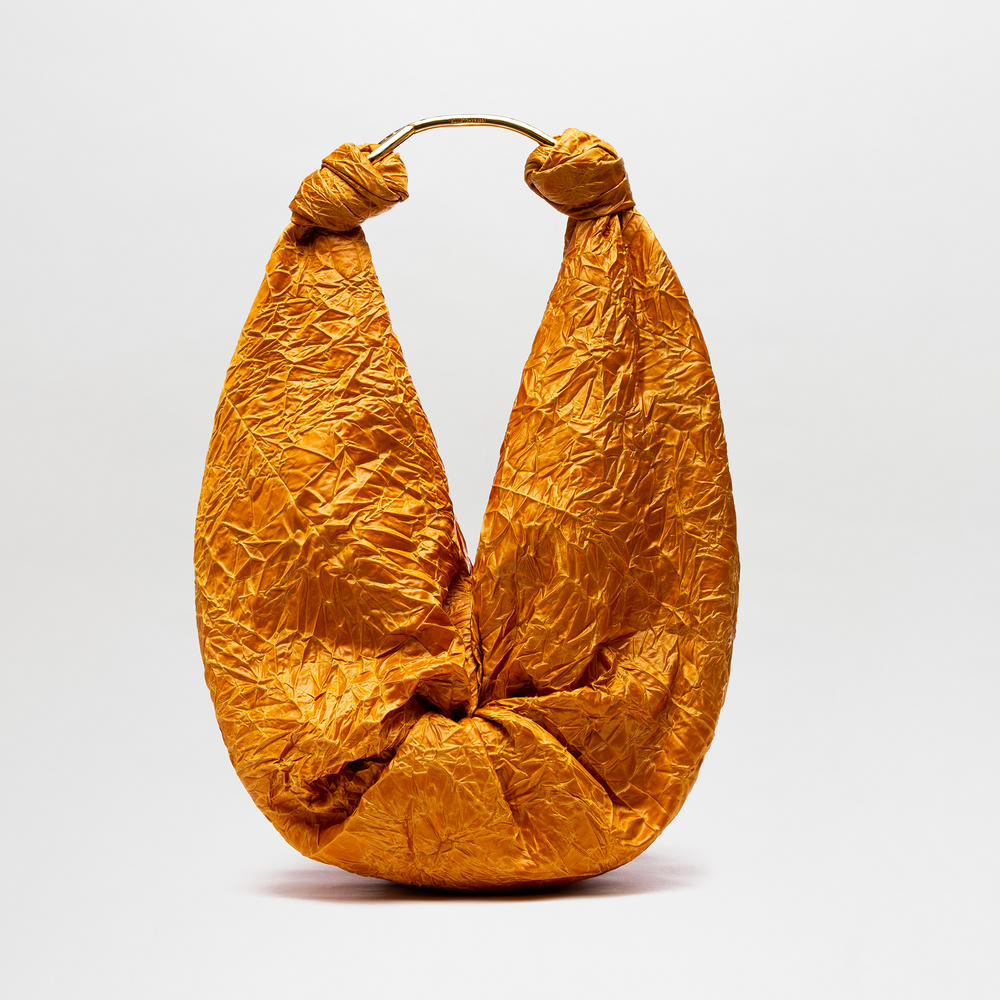 Gold crumpled paper handbag on a white background