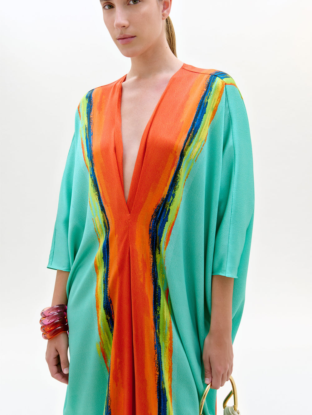 Woman wearing a colorful dress with a white background