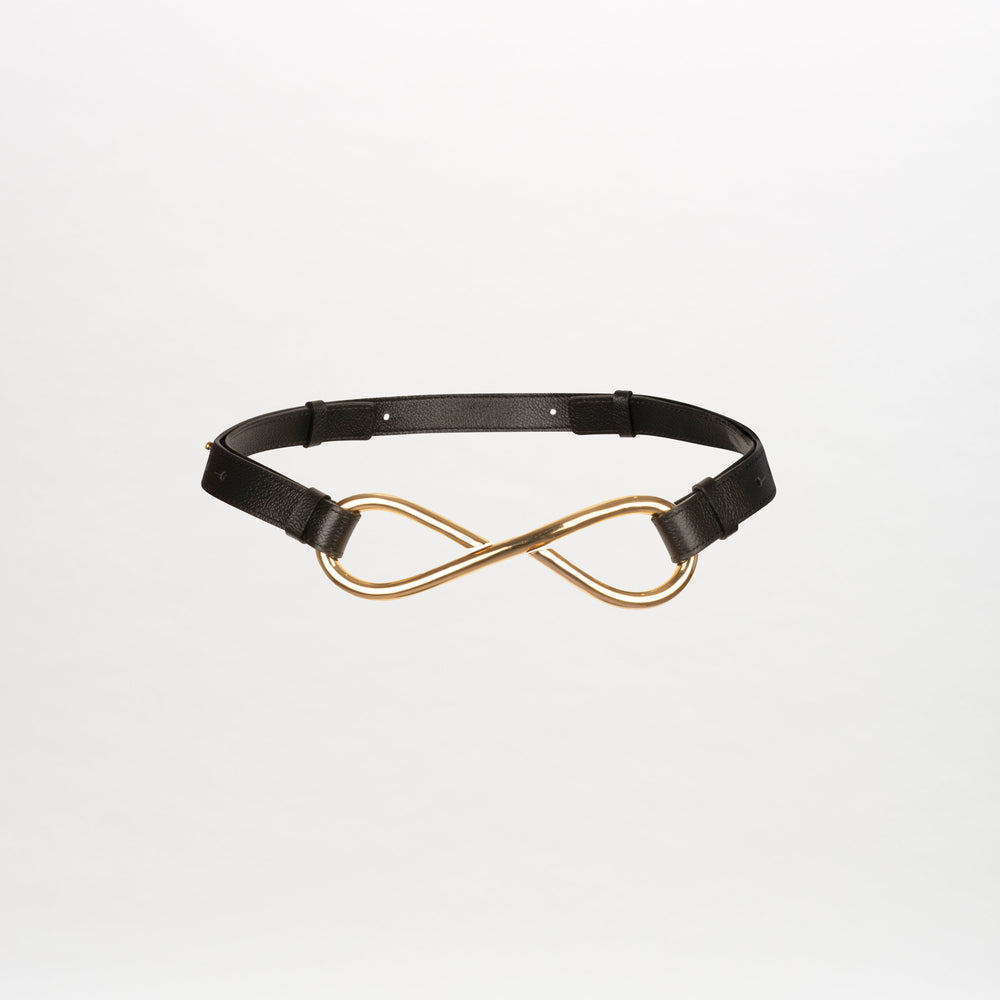 The Oihana Belt, a leather accessory with an adjustable strap and a gold infinity-shaped buckle, is showcased on a plain white background.