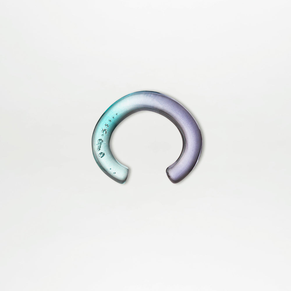 Gradient ear cuff on a light gray background