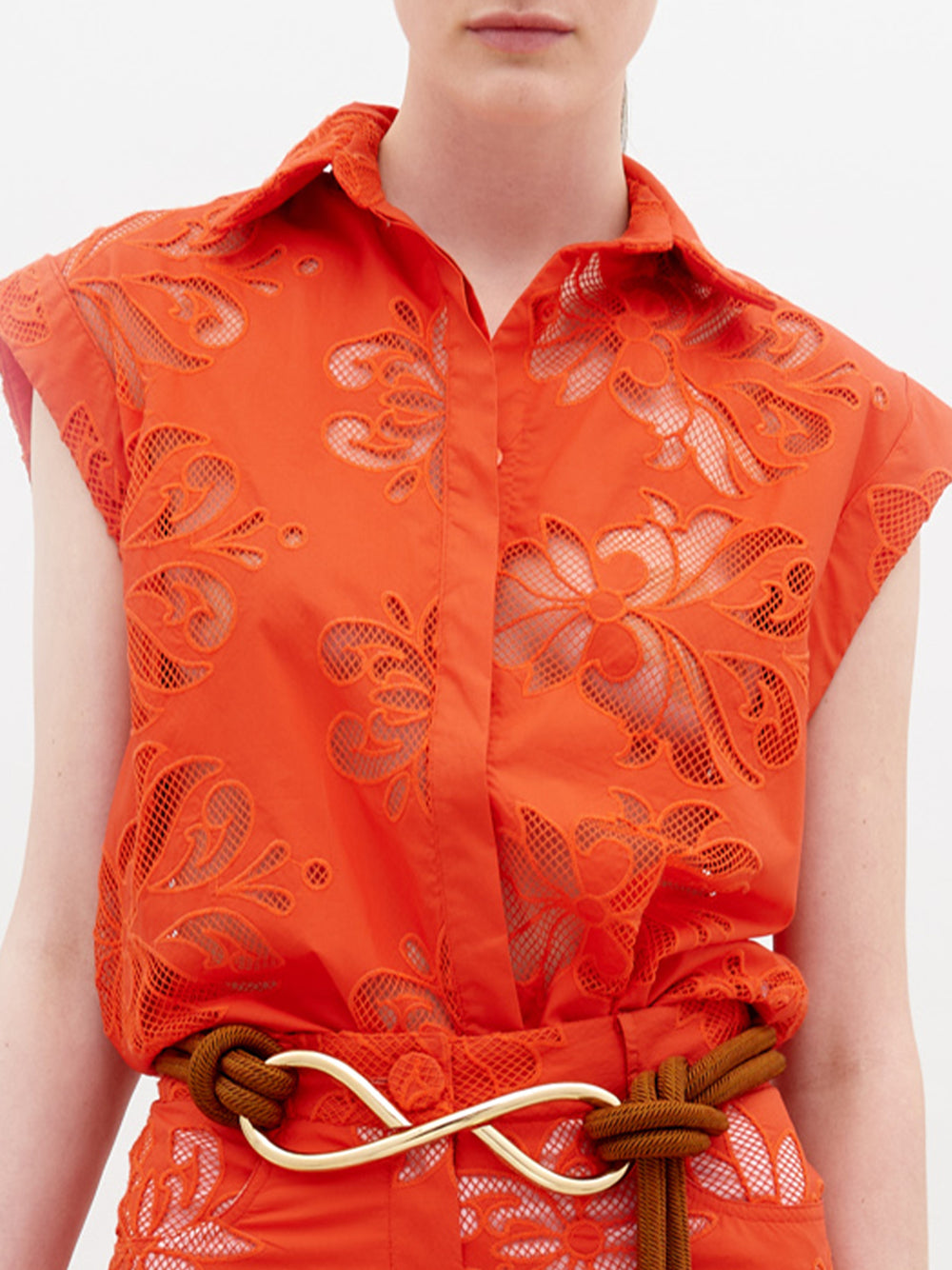 A person stands against a plain background wearing the Rina Blouse