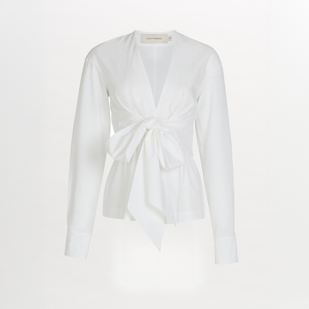 A Saanvi Blouse White with a v-shaped neckline and a bow at the neck.
