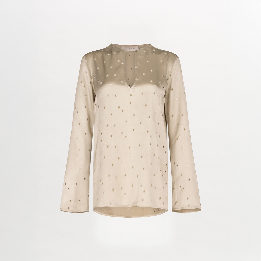 A Tosca Blouse Ecru with a keyhole neckline and gold stars on the fabric texture.