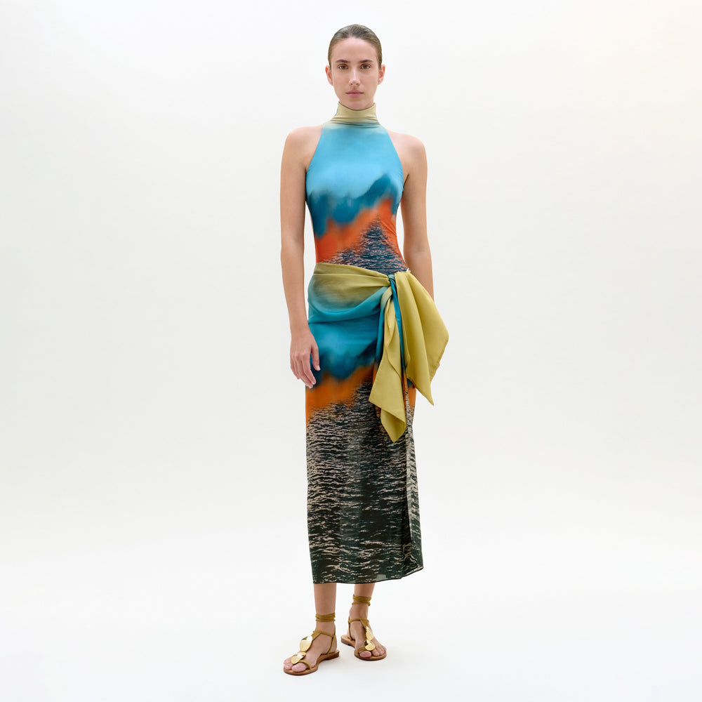 Model wearing a colorful dress with a gradient effect on a white background