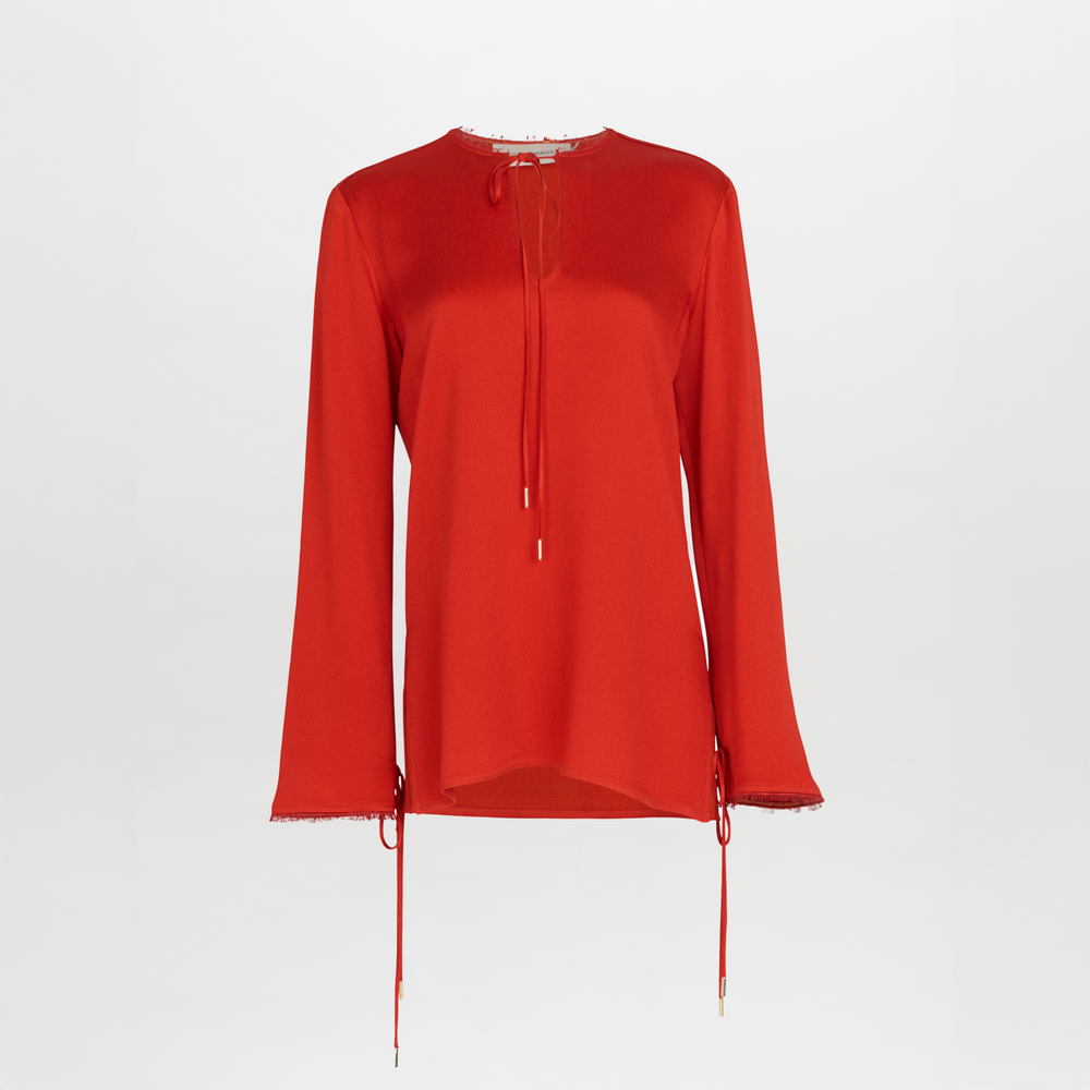 A figure-flattering Zafra Blouse Rouge with lace trim.