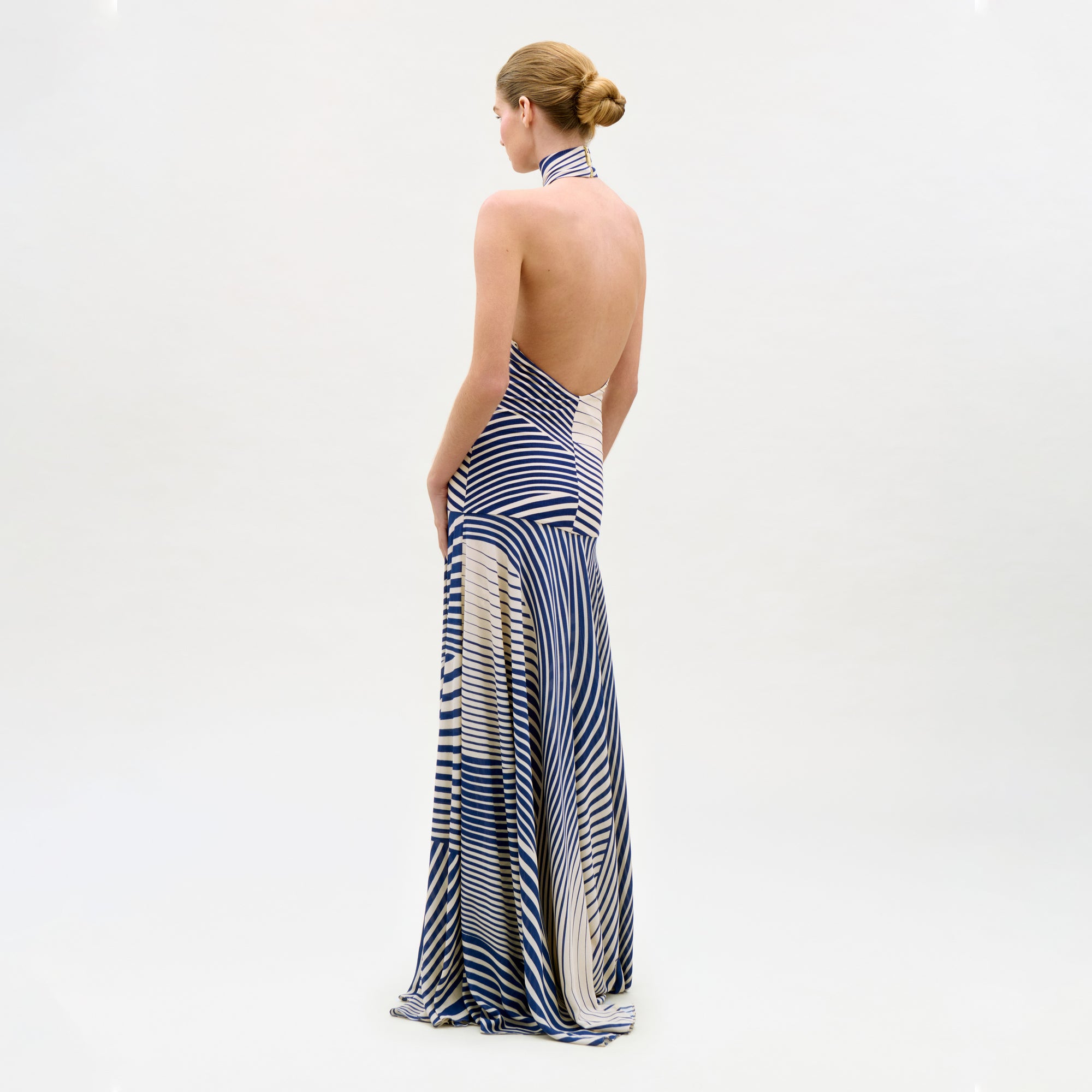 Woman wearing a blue and white striped dress on a white background