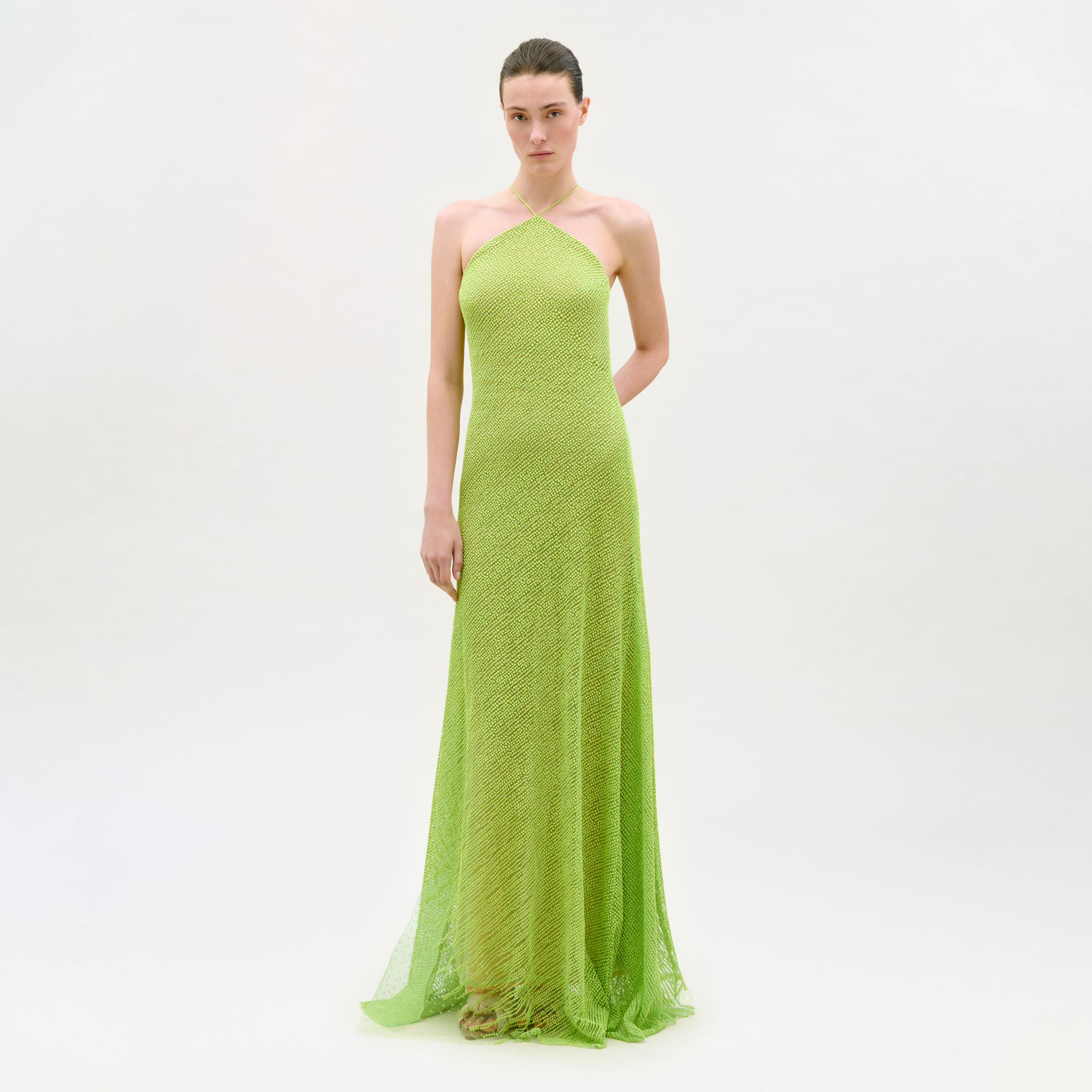 Woman wearing a green strapless gown on a white background