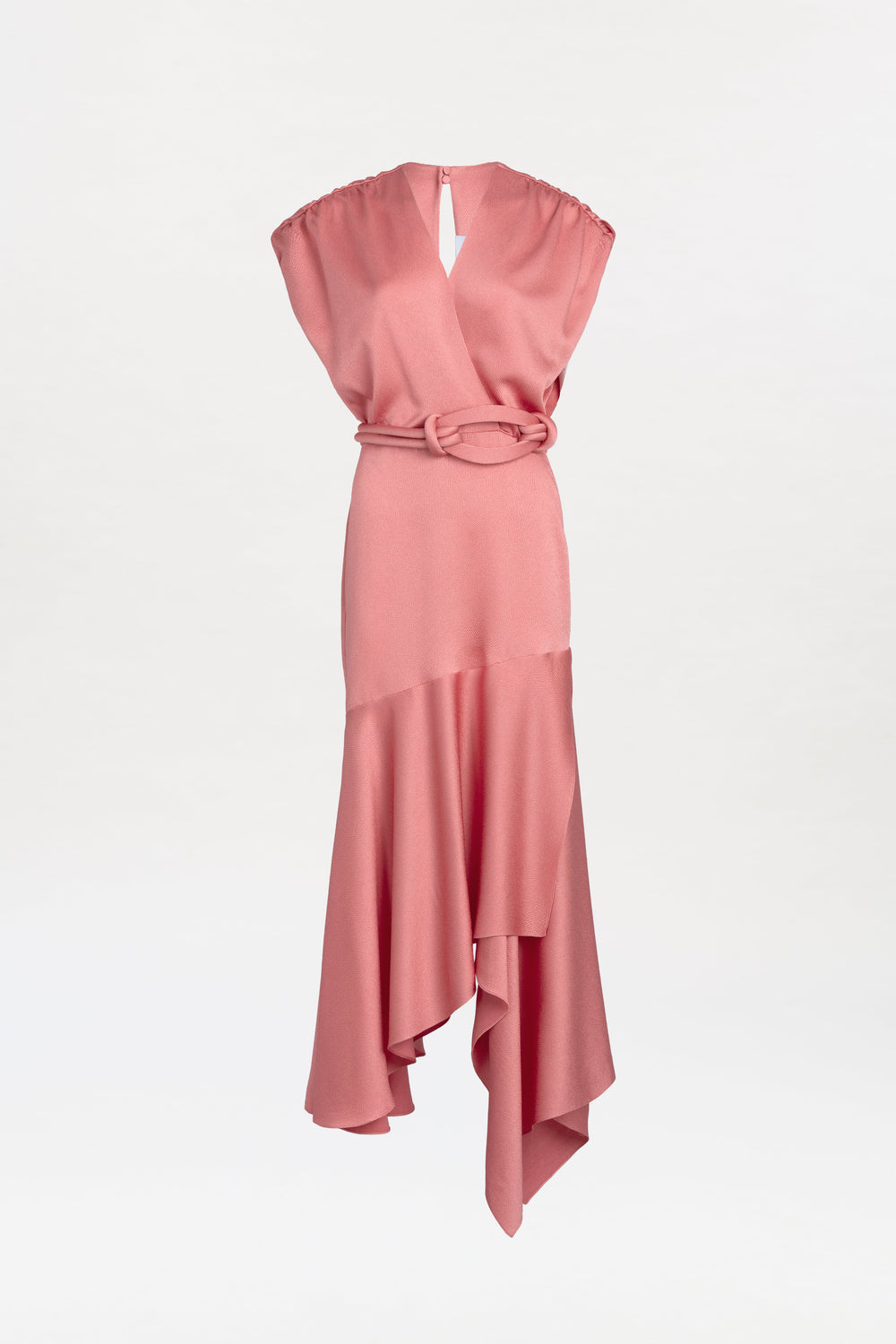 Introducing the Protea Dress: a sleeveless pink dress featuring a V-neckline, belted waist, and an asymmetrical hemline. Its soft fabric drapes elegantly, creating a flowing silhouette against a plain white background.