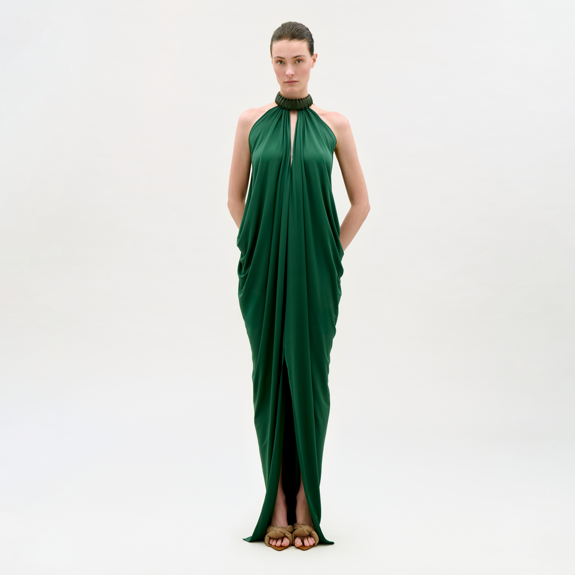 Woman wearing a green evening gown on a white background