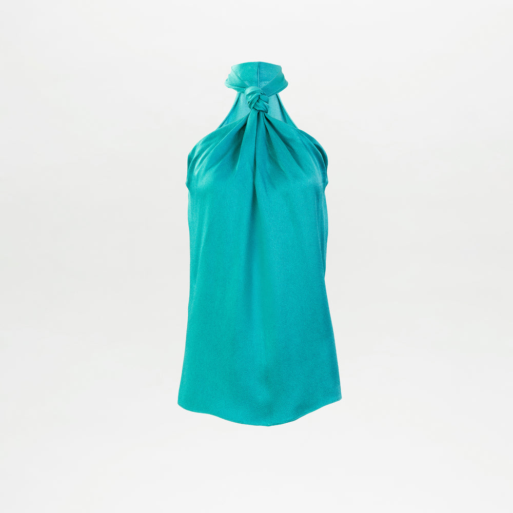 The Teagan Blouse, crafted in Colombia, features a turquoise halter-neck design with a chic knot detail at the neckline and is displayed on a plain white background.