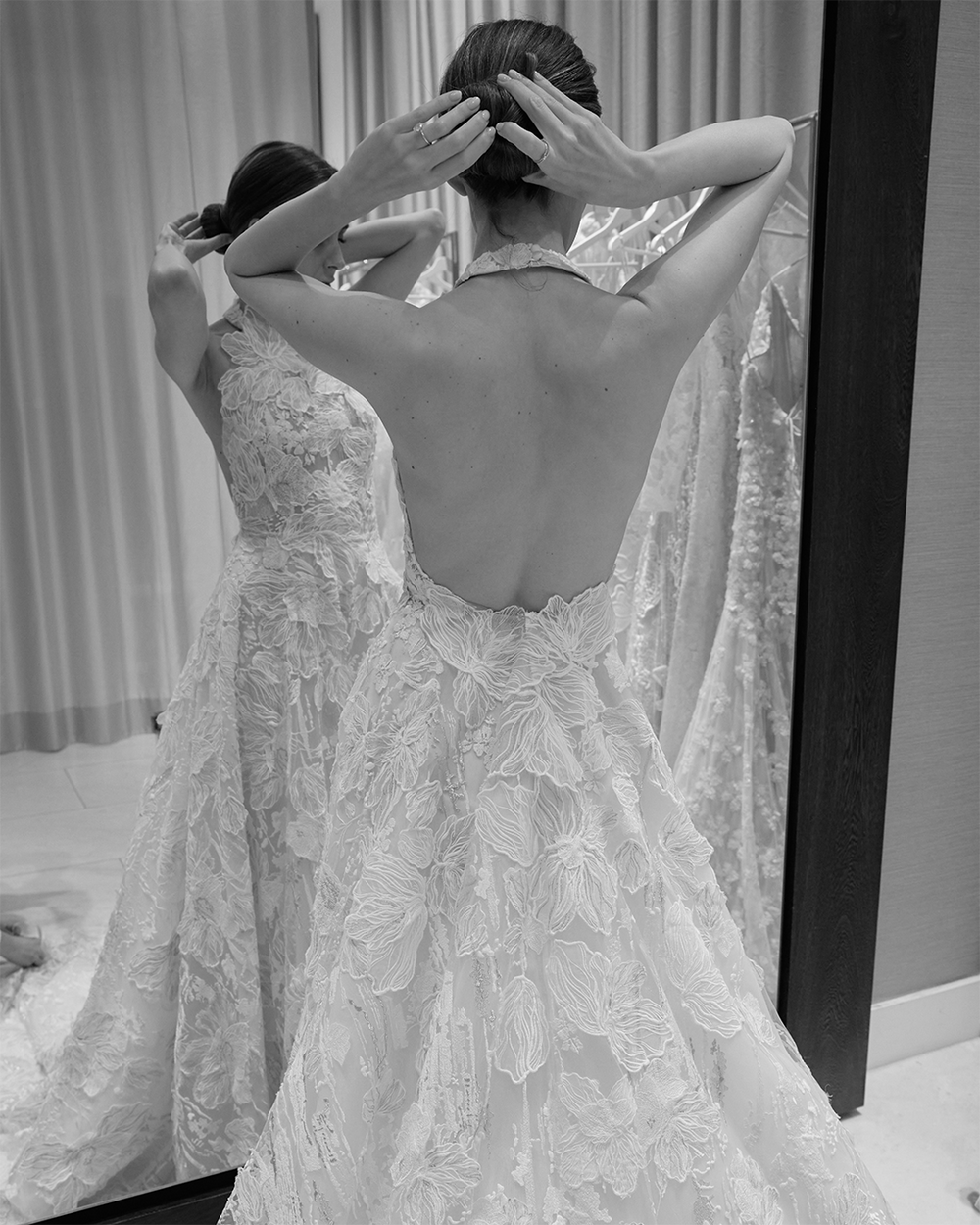 A-woman-adjusts-her-hair-in-bridal-dress