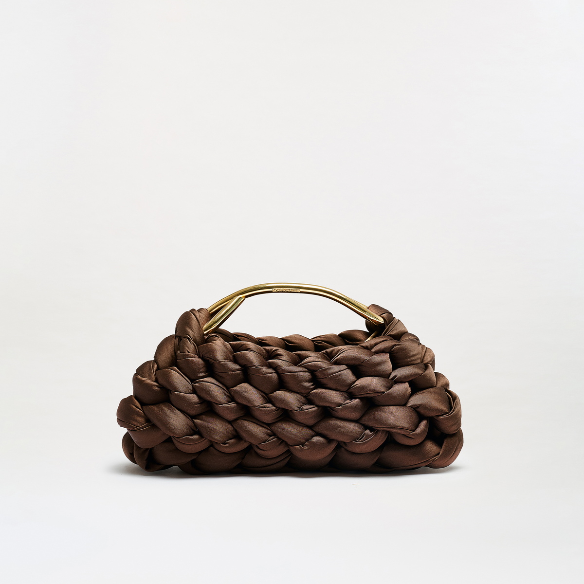 A brown woven leather handbag with a structured, braided texture and a curved gold-tone metal handle, photographed on a clean white studio background.