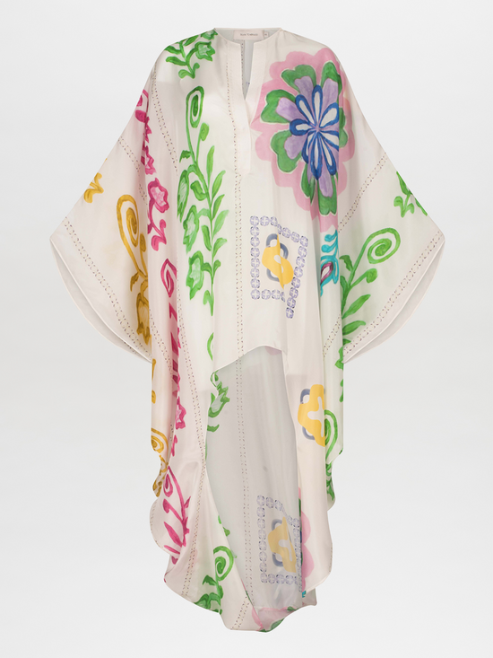 A white poncho with Adaya Tunic Multicolor Floral Print designs.