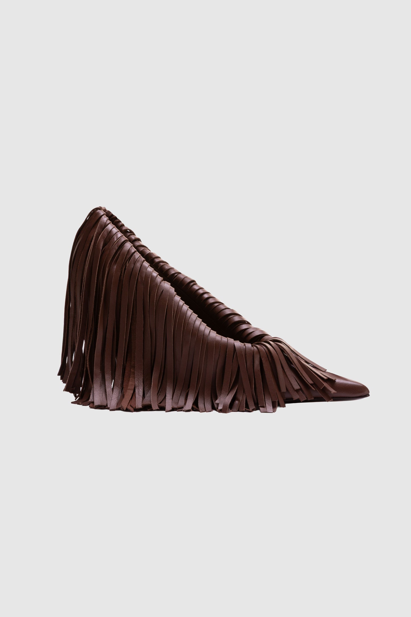 The Amelia Heels are brown pointed-toe high heels adorned with long, layered leather fringe, shown on a plain light grey background.