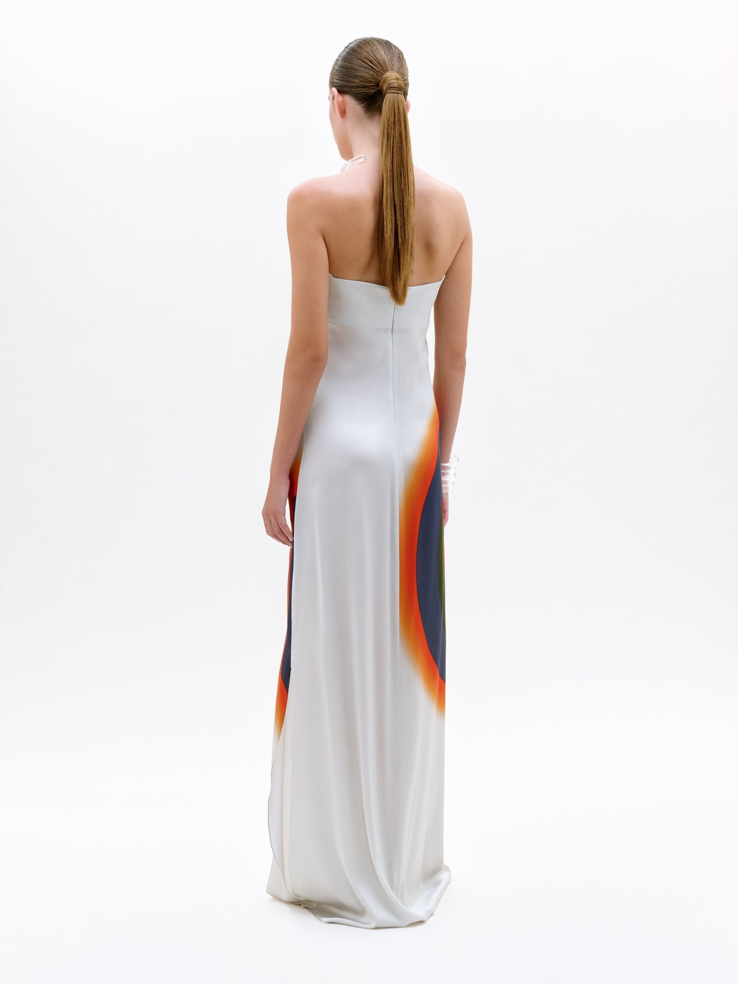 Woman wearing a white dress with colorful gradient on a white background