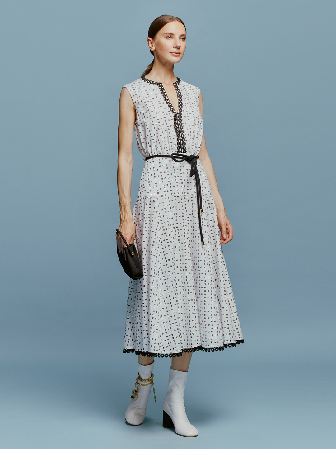 The model is wearing a Bora Dress White Black Dots.