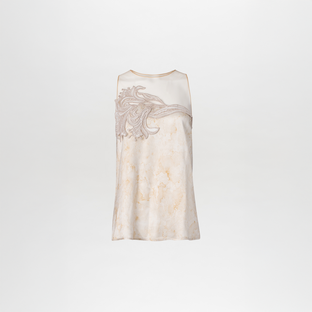 A woman wearing a Brisa Blouse Cream Abstract Print jumpsuit and clutch available for pre-order with a specified ship by date.