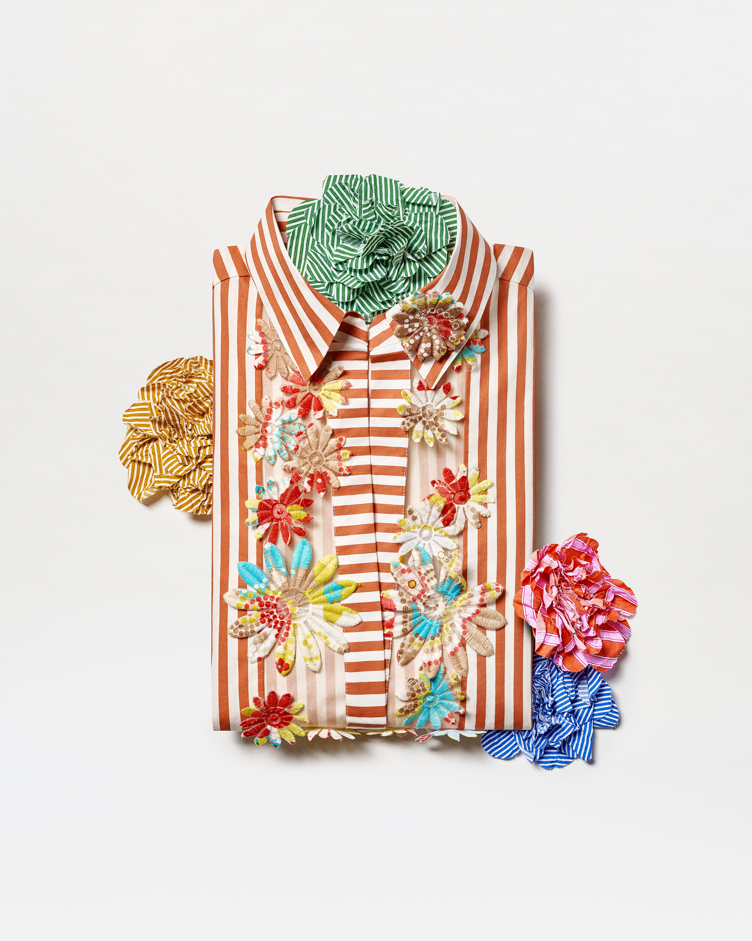 Colorful striped shirt with floral patterns on a white background
