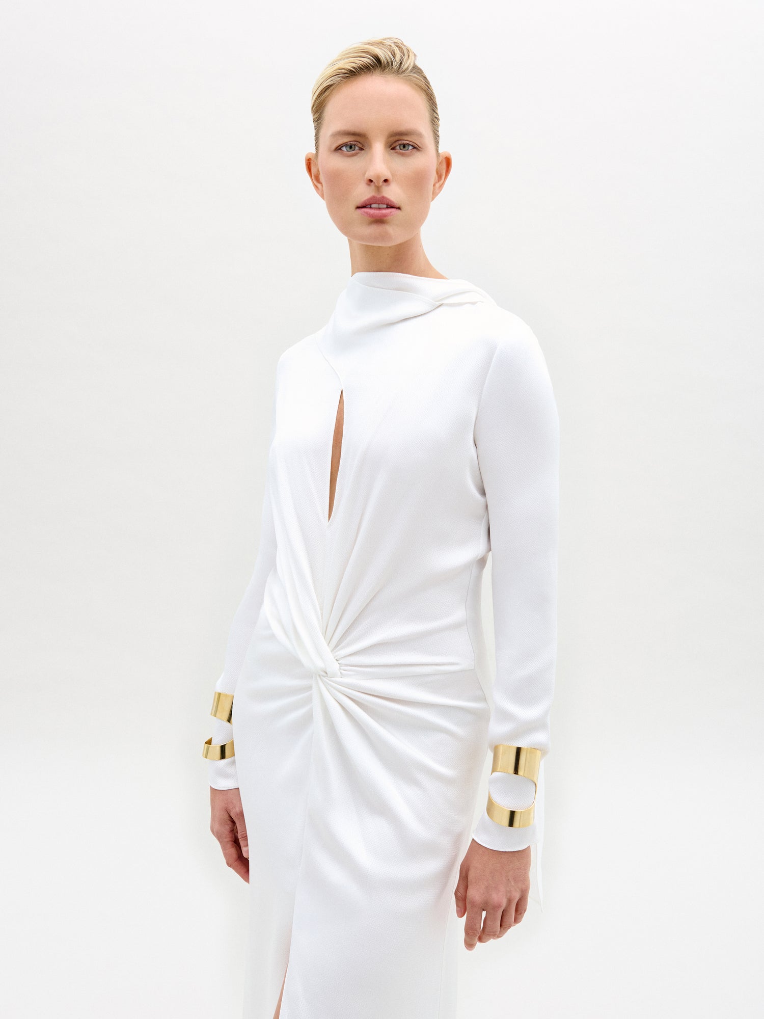 Model wearing a white dress on a white background