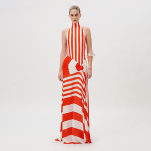 The Belona Dress is a floor-length, high-neck crepe de viscose dress featuring a vertical and horizontal red and white striped pattern with a knotted waist detail.