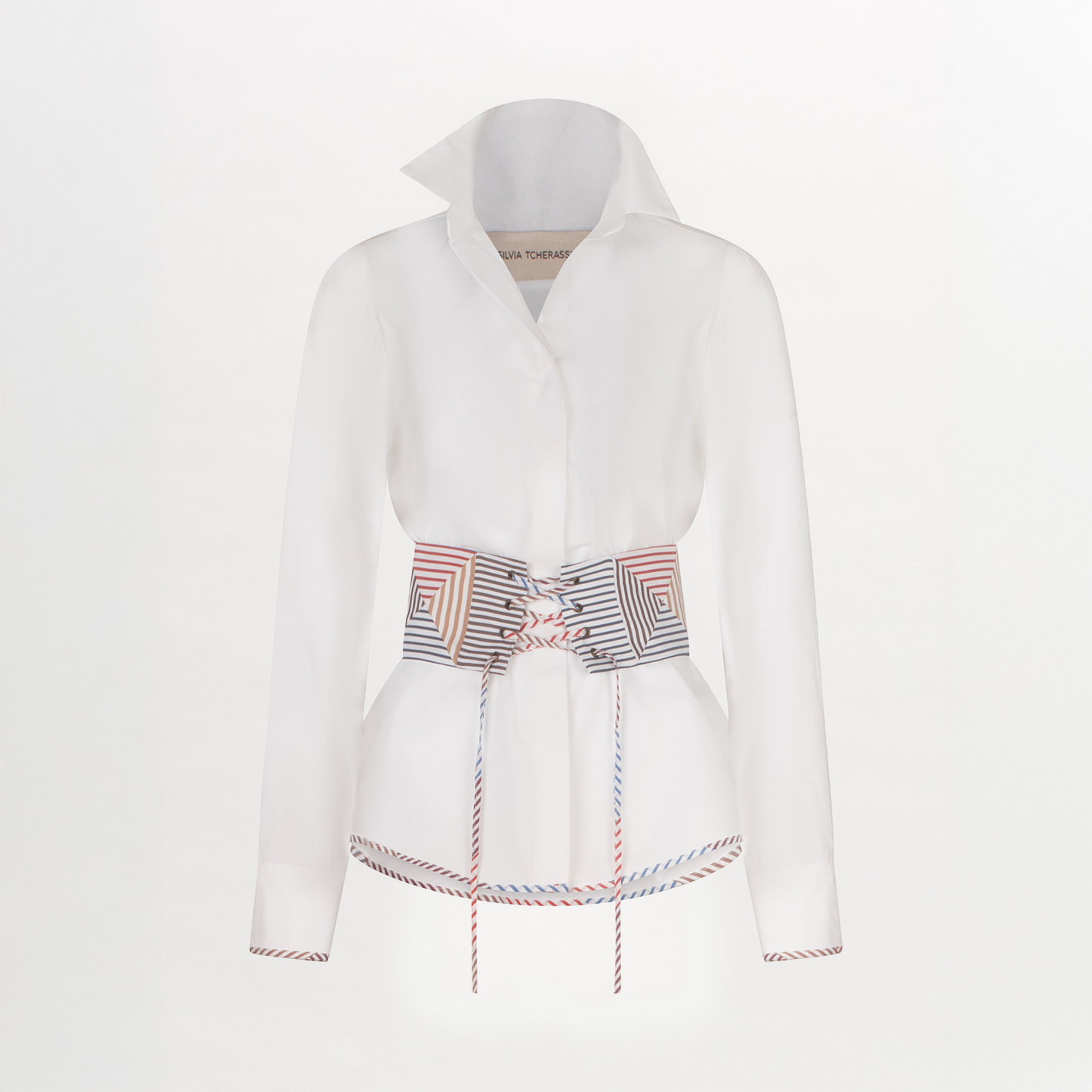 A Berenice Blouse White with a colorful belt and a fitted silhouette.