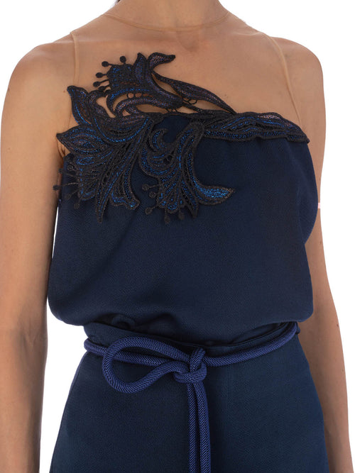 A Brisa Blouse Navy with a white upper and dark blue lower section, featuring intricate guipure lace detailing on the chest.