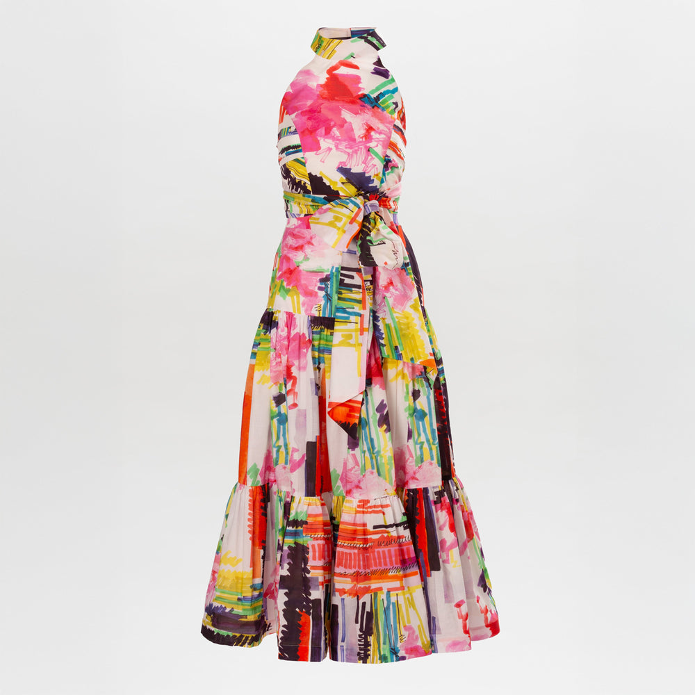 The Dilara Dress Set is a sleeveless, floor-length dress with an elegant halter neckline, a vibrant abstract watercolor print in pink, red, yellow, green, and black, a fitted waist, and a flowing tiered maxi skirt crafted from premium Italian textile.