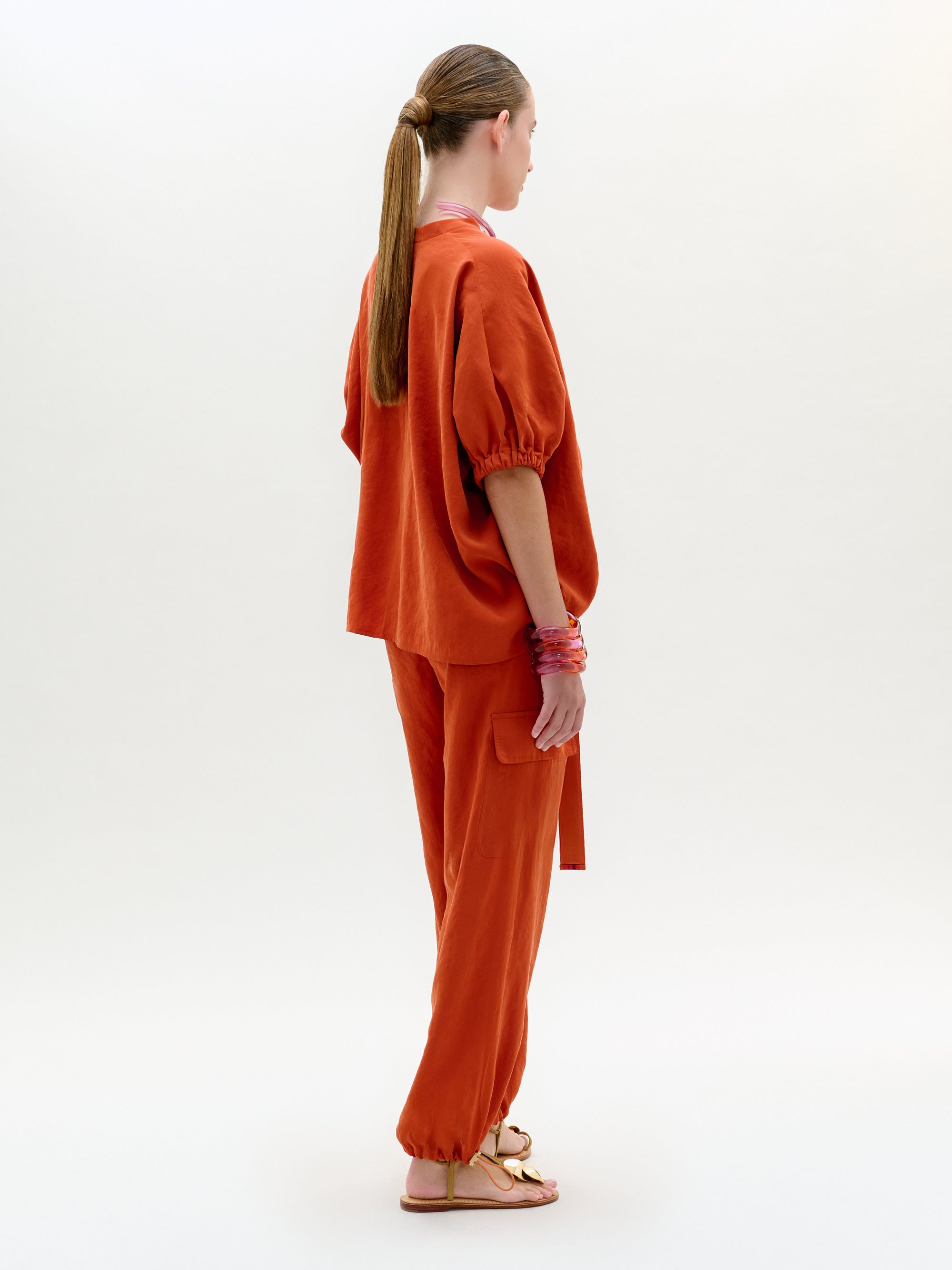 Person wearing an orange outfit on a white background