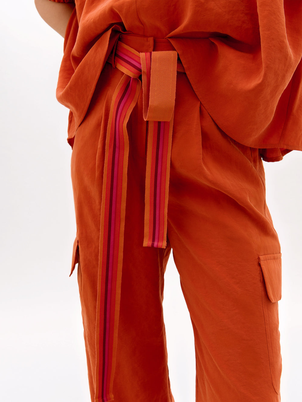 Orange outfit with a belt on a white background