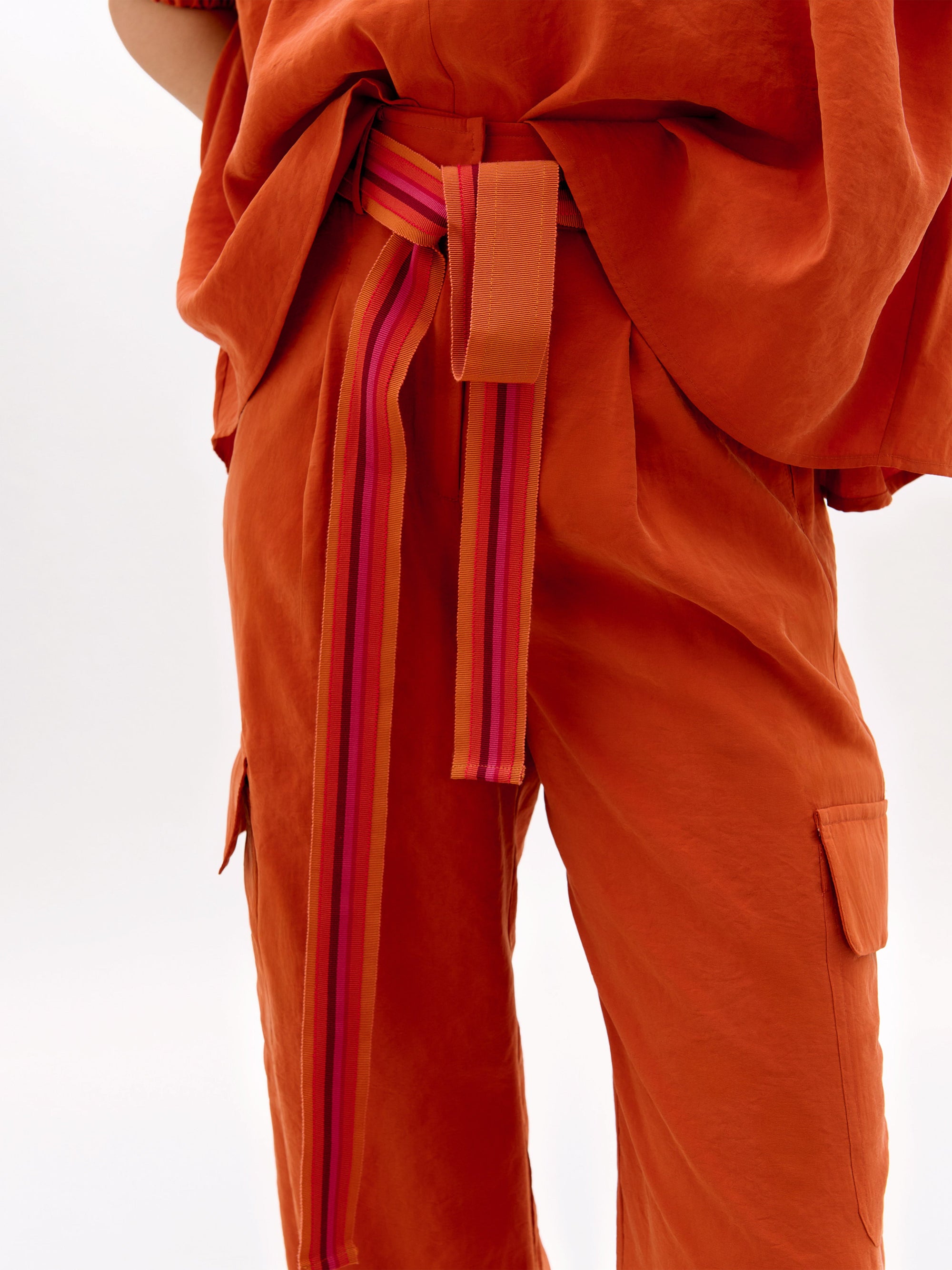 Orange outfit with a belt on a white background