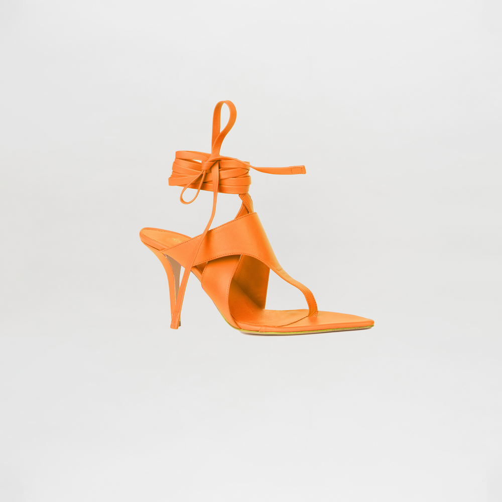 Orange high-heeled sandal on a light gray background