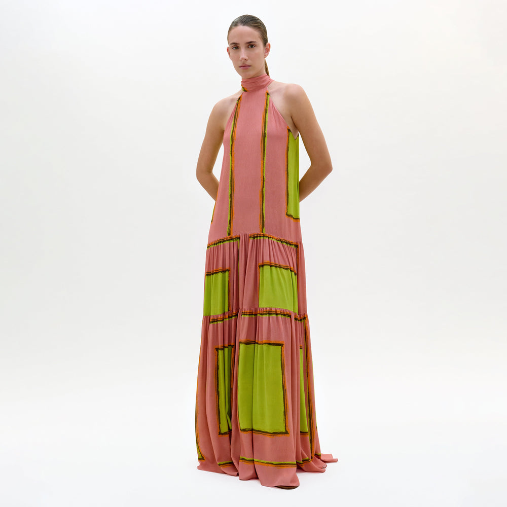 Woman wearing a pink and green dress on a white background