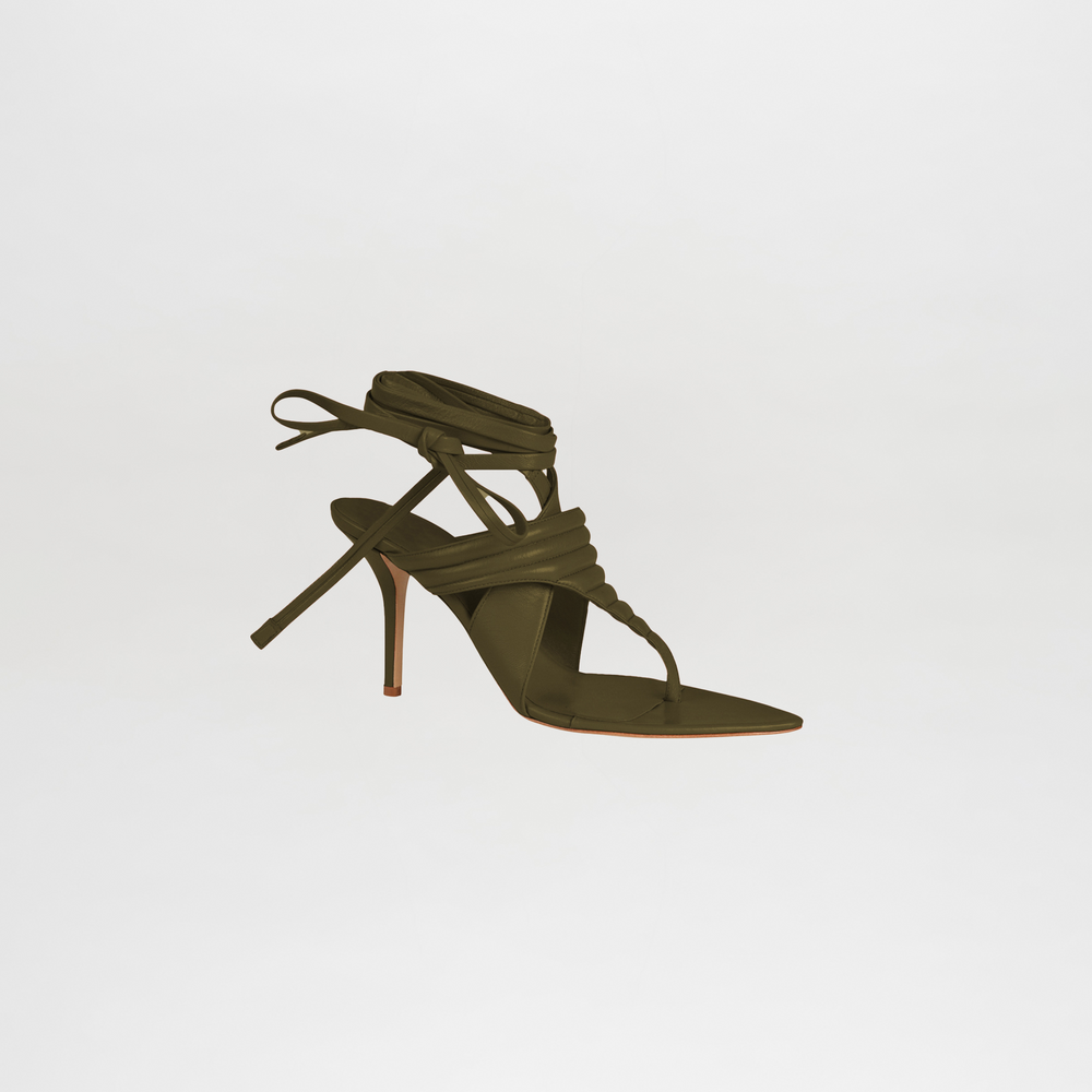 Green high-heeled sandal with strappy design on a light gray background