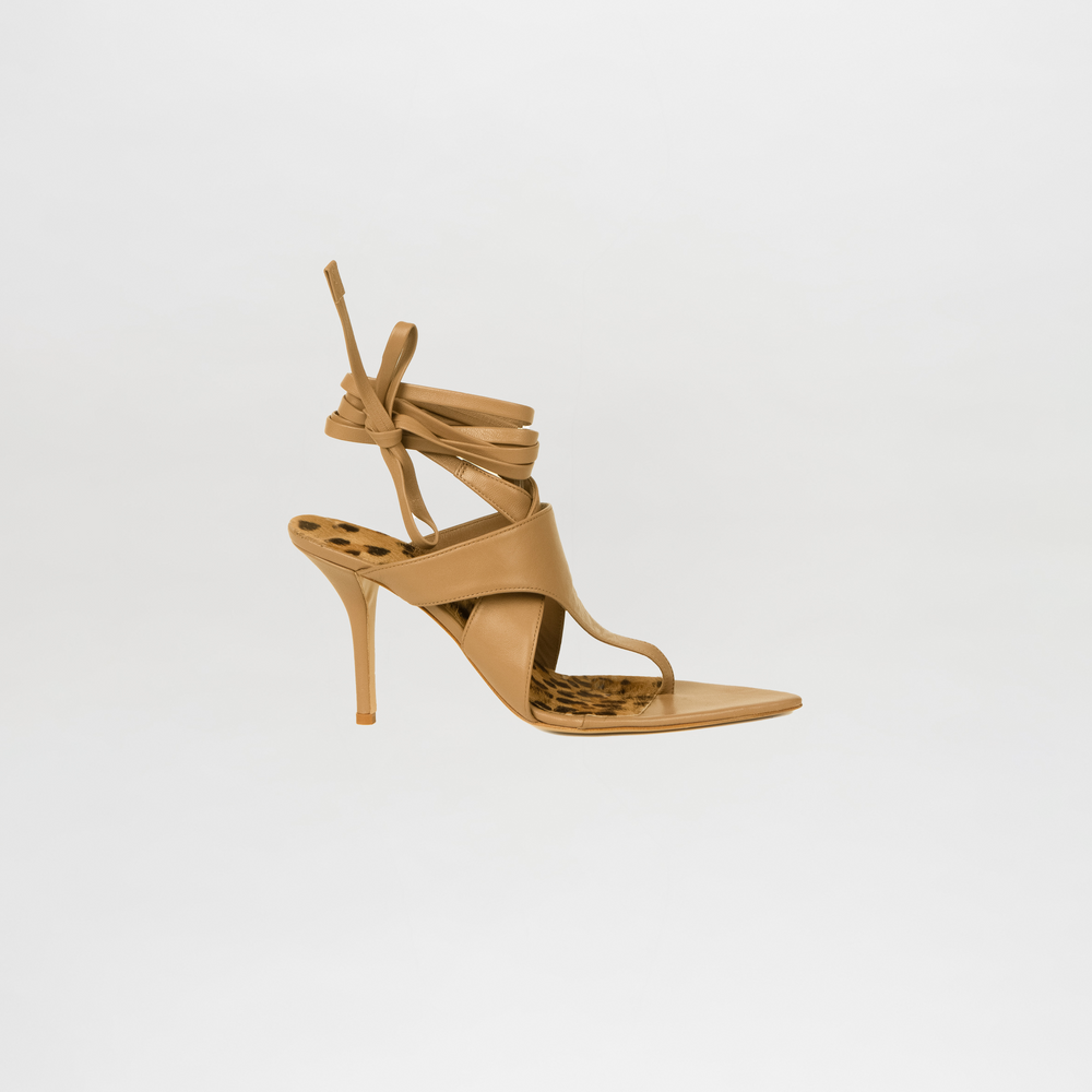 Tan high-heeled sandal with strappy design on a light gray background
