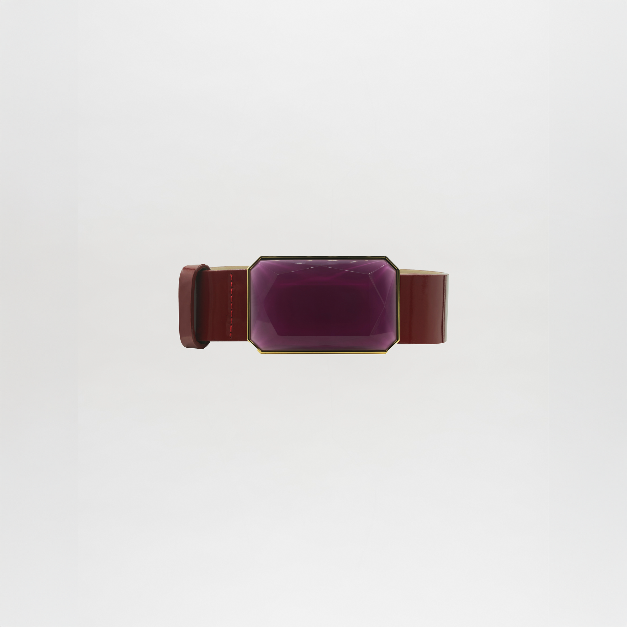 The Dora Belt features a wide brown band with a large, faceted rectangular purple gem at the center. Please allow standard processing and shipping time for delivery. Shown against a plain white background.