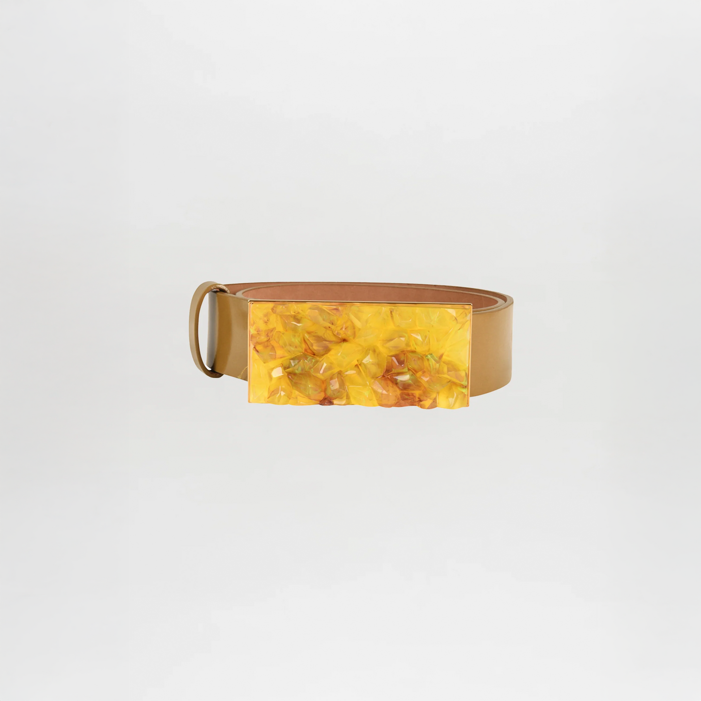 The Dora Belt Mustard by Silvia Tcherassi is crafted from camel leather in tan and features a large rectangular yellow marbled buckle, shown on a plain white background.